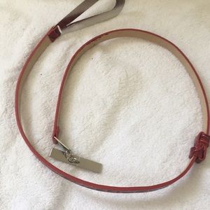 Red belt with silver buckle